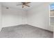 Bright bedroom with neutral walls, gray carpet, a window, and a closet door at 865 S Quebec St # 101B, Denver, CO 80247