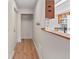 Inviting entryway featuring wood floors, coat closet, and a breakfast bar to the kitchen at 865 S Quebec St # 101B, Denver, CO 80247