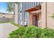 Charming condo exterior with muted tones and landscaping and a covered entry and a shared bench at 865 S Quebec St # 101B, Denver, CO 80247