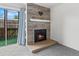 Stylish fireplace with decorative tile surround and mantle, alongside a sliding glass door to the patio at 865 S Quebec St # 101B, Denver, CO 80247