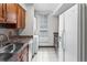 Well-equipped kitchen with laundry appliances and updated countertops at 865 S Quebec St # 101B, Denver, CO 80247