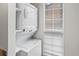This laundry room features a stacked washer and dryer unit with blinds on the nearby window at 865 S Quebec St # 101B, Denver, CO 80247