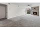 Bright living room features gray carpet, and a stylish fireplace with sliding glass door to patio at 865 S Quebec St # 101B, Denver, CO 80247