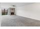 Neutral living room features gray carpet, white walls, and a fireplace with stylish tile surround at 865 S Quebec St # 101B, Denver, CO 80247