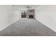 Open living room features neutral walls, gray carpet, and a fireplace with stylish tile surround at 865 S Quebec St # 101B, Denver, CO 80247
