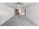 Neutral living room features gray carpet and a view of the kitchen at 865 S Quebec St # 101B, Denver, CO 80247