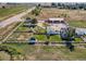 Panoramic aerial view of a charming house with a fenced yard, outbuildings and established trees at 3550 E 160Th Ave, Thornton, CO 80602