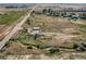 Scenic aerial view of a property with a creek and outbuildings at 3550 E 160Th Ave, Thornton, CO 80602