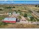 An aerial view of an expansive property featuring multiple buildings, fenced yards, and a barn at 3550 E 160Th Ave, Thornton, CO 80602