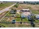A rural property featuring multiple homes, an expansive shop, fenced pens, and mature landscaping at 3550 E 160Th Ave, Thornton, CO 80602