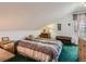 A cozy bedroom under a vaulted ceiling with a soft bed, wooden furniture and green carpet at 3550 E 160Th Ave, Thornton, CO 80602