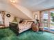 Quaint bedroom with slanted ceilings, a bed, and balcony access with a view at 3550 E 160Th Ave, Thornton, CO 80602