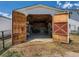 Open garage with exposed wooden doors revealing ample storage space, tools, and equipment at 3550 E 160Th Ave, Thornton, CO 80602