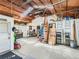 A large shop or garage featuring tall ceilings, a concrete floor, and lots of storage and workspace at 3550 E 160Th Ave, Thornton, CO 80602