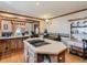 Bright kitchen features island cooktop, light-colored walls, and access to dining area at 3550 E 160Th Ave, Thornton, CO 80602