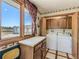 A utilitarian laundry room featuring a front load washer and dryer and lots of cabinet space at 3550 E 160Th Ave, Thornton, CO 80602