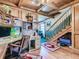 Cozy wood-paneled office featuring built-in desk, hardwood floors, and staircase access at 3550 E 160Th Ave, Thornton, CO 80602
