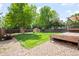 Well-manicured backyard with a large lawn, wooden fence, shed, and play structure at 10890 Depew Pl, Broomfield, CO 80020