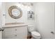 Bathroom featuring a sink, vanity and toilet with a decorated mirror at 10890 Depew Pl, Broomfield, CO 80020