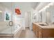 Bright bathroom featuring a double vanity, soaking tub, and glass shower enclosure at 10890 Depew Pl, Broomfield, CO 80020