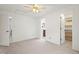Bedroom with neutral carpet, a ceiling fan and views of two walk-in closets and an en-suite bathroom at 10890 Depew Pl, Broomfield, CO 80020