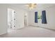 Bedroom with neutral carpet, a ceiling fan and a view of an en-suite toilet and closet at 10890 Depew Pl, Broomfield, CO 80020