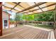 View of an expansive outdoor deck with wooden railings, awning, and a backyard at 10890 Depew Pl, Broomfield, CO 80020