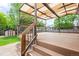 Large outdoor deck with awning provides shade, stairs, and views of the backyard at 10890 Depew Pl, Broomfield, CO 80020