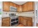 Well-equipped kitchen featuring granite countertops, stainless steel appliances, and custom cabinetry at 10890 Depew Pl, Broomfield, CO 80020