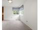 Bright living room with natural light, neutral carpeting, and view to a kitchen at 10890 Depew Pl, Broomfield, CO 80020