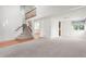 Bright living room featuring high ceilings, plush carpeting and a staircase to the upper level at 10890 Depew Pl, Broomfield, CO 80020