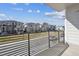 Neighborhood view from a private balcony; steel railing offers unobstructed views of homes and well-manicured lawns at 12270 Karls Ln, Northglenn, CO 80241