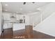 Bright kitchen with white cabinets, a kitchen island, stainless steel appliances and hardwood floors, an open and inviting space at 12270 Karls Ln, Northglenn, CO 80241