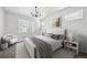 Airy main bedroom with a patterned rug, chandelier, and ample natural light at 12270 Karls Ln, Northglenn, CO 80241