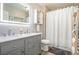 This remodeled bathroom has a double vanity, tiled shower, and modern decor at 3336 White Oak Ln, Highlands Ranch, CO 80129