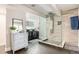 This luxurious bathroom features a glass enclosed shower, tiled floor, and double sinks at 3336 White Oak Ln, Highlands Ranch, CO 80129