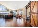 Spacious kitchen with hardwood floors, stainless steel appliances, and a large sliding barn door at 3336 White Oak Ln, Highlands Ranch, CO 80129