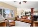 Spacious living room featuring a plush leather sofa, large windows, and an open floor plan at 3336 White Oak Ln, Highlands Ranch, CO 80129