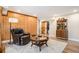 Comfortable living room features wood wall, hardwood floors and sliding barn door access to another room at 3336 White Oak Ln, Highlands Ranch, CO 80129