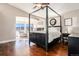 Luxurious main bedroom featuring a four-poster bed, cozy seating area, and fireplace at 3336 White Oak Ln, Highlands Ranch, CO 80129