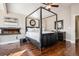 This main bedroom has a canopy bed, hardwood floors, and a modern fireplace at 3336 White Oak Ln, Highlands Ranch, CO 80129