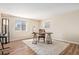 This home office boasts natural light, hardwood floors, a desk and chair, and a modern aesthetic at 3336 White Oak Ln, Highlands Ranch, CO 80129