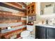 Unique powder room with stylish wood accent wall, modern fixtures, and vanity sink at 3336 White Oak Ln, Highlands Ranch, CO 80129