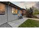 Backyard with seating and lawn area with grey brick exterior at 561 Cook St, Denver, CO 80206