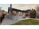 Backyard with patio area, mature trees, and a grey brick exterior at 561 Cook St, Denver, CO 80206