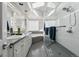Bright bathroom featuring skylights, double vanity, glass shower, and separate soaking tub with textured glass window at 561 Cook St, Denver, CO 80206