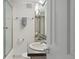 Clean bathroom with shower, modern sink, and ample lighting at 561 Cook St, Denver, CO 80206