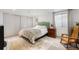 Bright bedroom with a queen bed, closet with sliding doors, and neutral walls at 561 Cook St, Denver, CO 80206