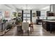 Bright dining area with modern chandelier, view to living room and kitchen at 561 Cook St, Denver, CO 80206