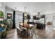 The dining area features a modern chandelier, view to the living room and kitchen at 561 Cook St, Denver, CO 80206